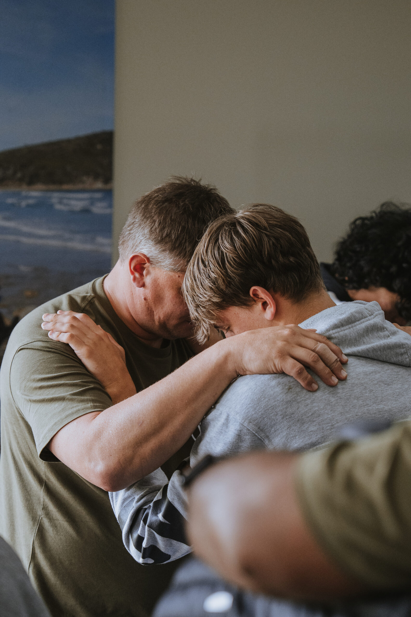 Father and son embrace at The Royal Hood event